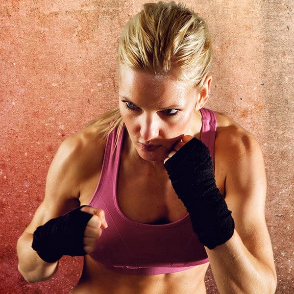 Mixed Martial Arts Lessons for Adults in Carrolton TX - Lady Kickboxing Focused Background